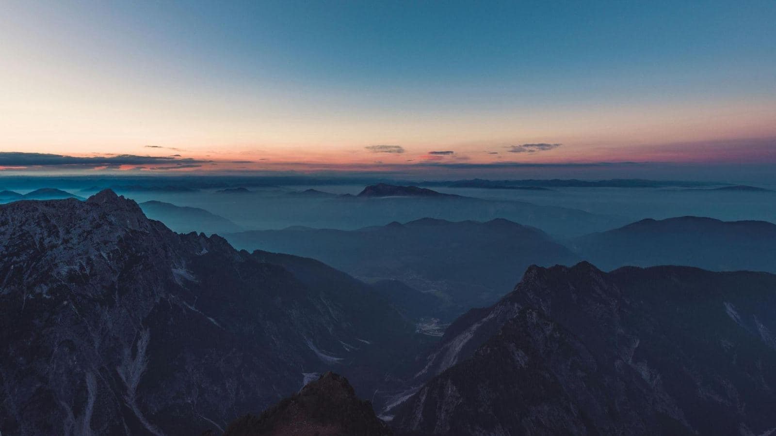 Mountain ridges above a sea of mist at dawn